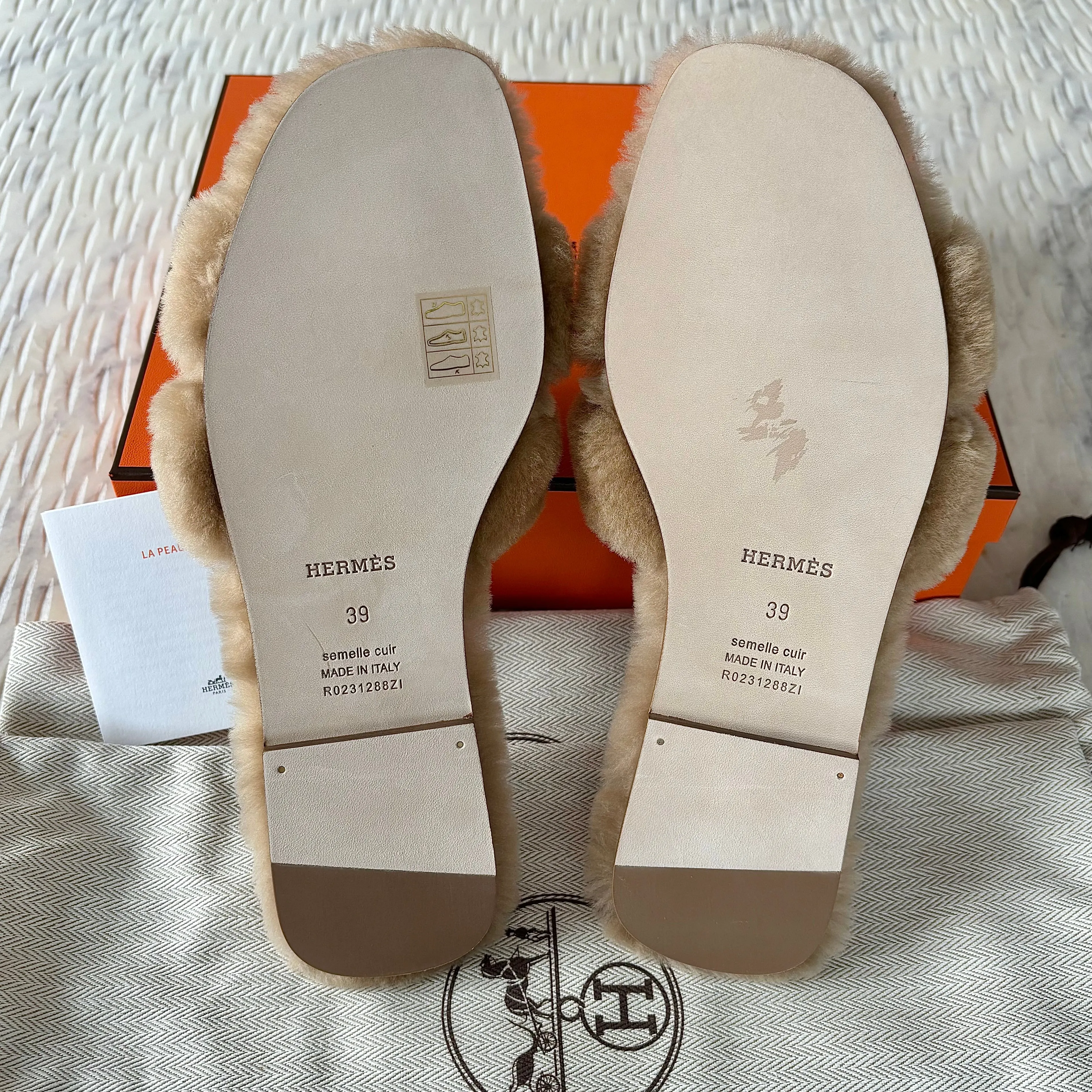 Sure! Here is the optimized title for the product you mentioned: Luxurious Hermes Shearling Oran Sandals in Elegant Beige